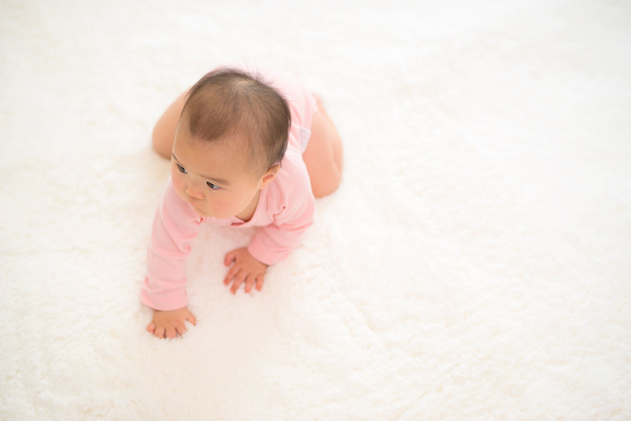 Baby crawling on mat